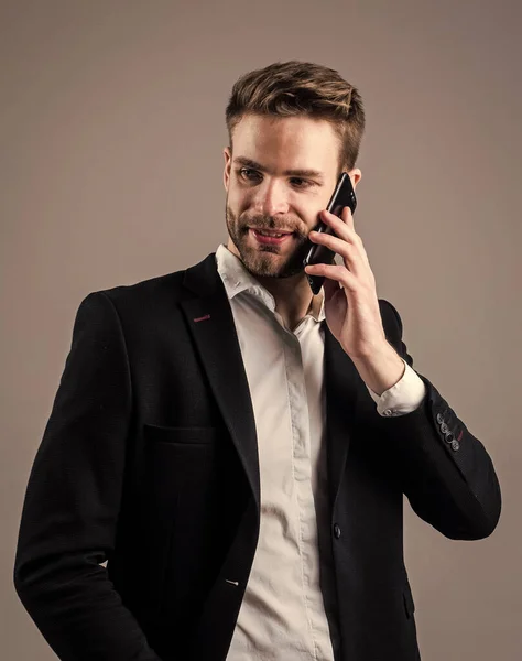 hello. communication. mens wear. confident businessman. young handsome guy in office suit. formal male speak on smartphone. bearded man with business look. fashion and beauty