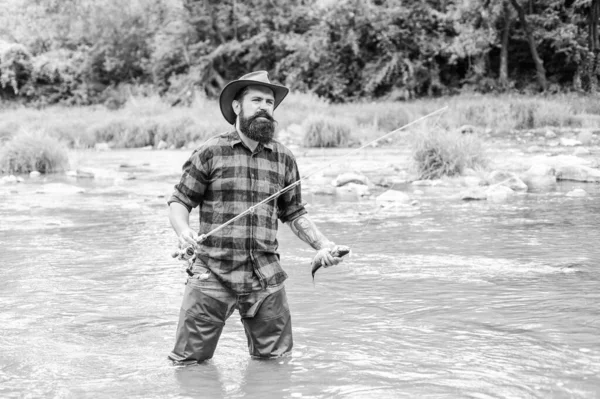 Desire meets a new Hobby. summer weekend. Happy fly fishing. mature man fly fishing. man catching fish. hobby and sport activity. bearded fisher in water. fisherman show fishing technique use rod — Stock Photo, Image