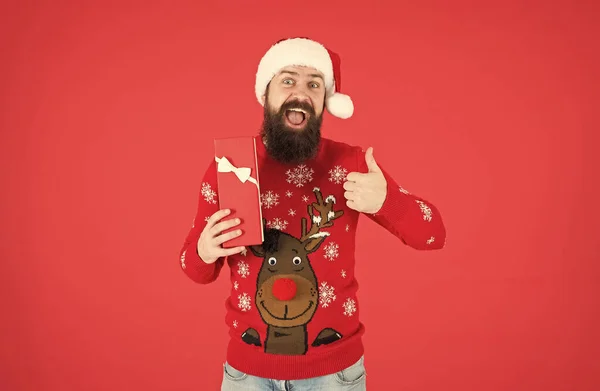 What a great surprise. winter holiday preparations. best present shopping sale. happy new year. merry christmas. cheerful bearded man in santa hat and sweater. brutal hipster celebrate xmas party — Stock Photo, Image