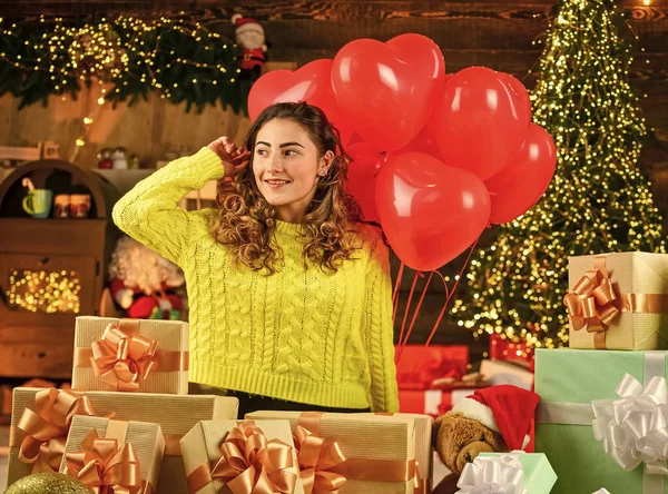 Woman enjoy cozy atmosphere. Decorate home. Xmas spirit. Happy girl christmas tree. Holiday celebration. Celebrate holiday. Holiday tradition. Red heart air balloon. Feeling loved. Happy new year
