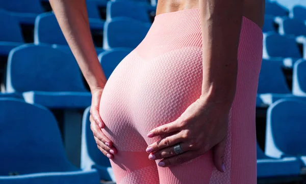 Lady has tight ass. sportive woman in sportswear. sexy woman on stadium. — Stockfoto