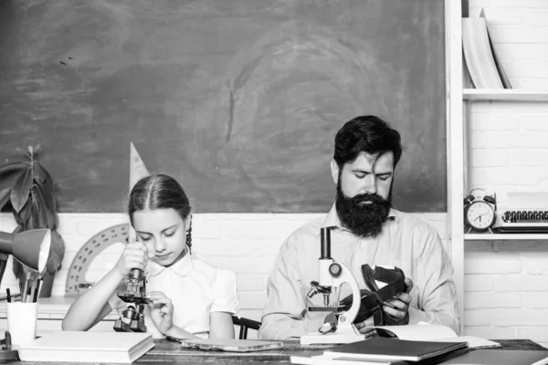 Education. biology chemistry lesson. education and knowledge. father and daughter study in classroom. bearded man teacher with small girl in classroom. back to school. math geometry — Stock Photo, Image