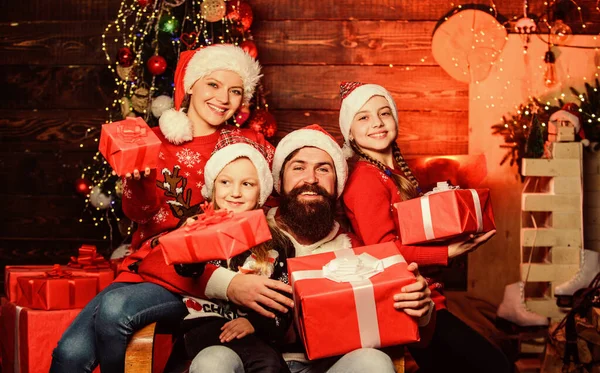 Christmas tradition. Family bonding activities. Christmas joy. Happy holidays. Parents and children opening christmas gifts. Father Santa claus and mother little daughters christmas tree background — Stock Photo, Image