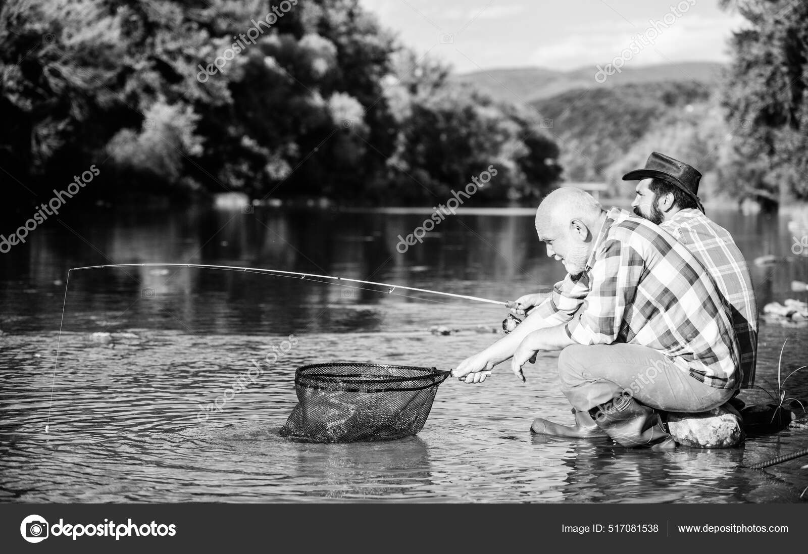 Retired father and mature bearded son. Two male friends fishing