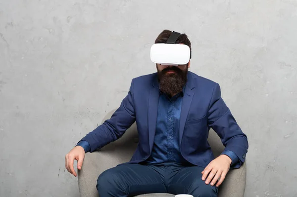 Immersion into virtual reality. Serious guy manager wear VR headset. Virtual immersion