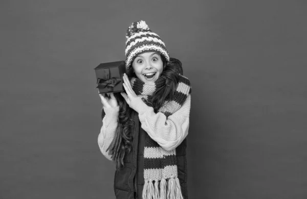 Kid with happy face wearing warm winter clothing and get ready for holidays buying gift box, shopping on boxing day — Stock Photo, Image