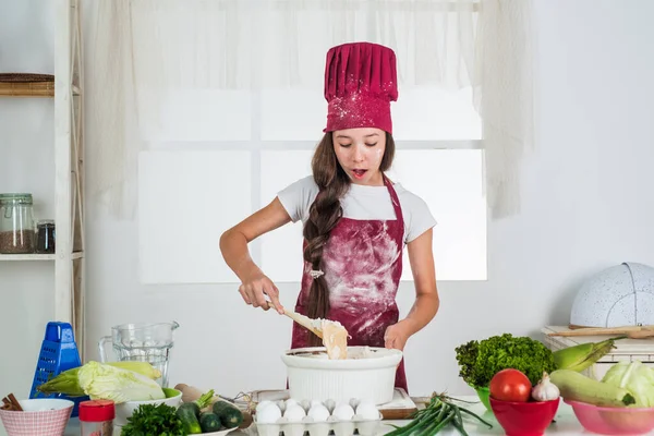 Criança suja em farinha na cozinha, preparando comida — Fotografia de Stock