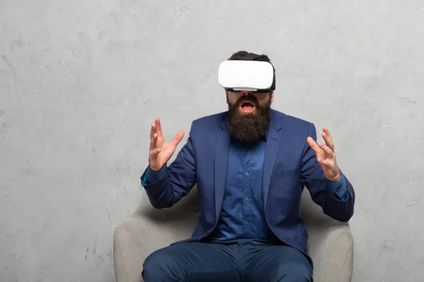 Shocked businessman discovering VR immersive technology through virtual reality headset, immersion