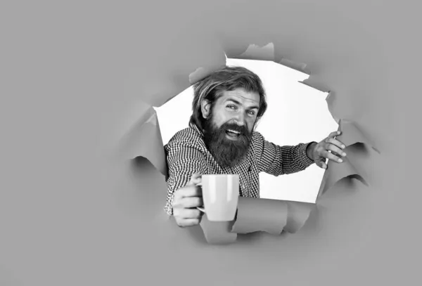 Cup of coffee in hand of cheerful bearded man, concept of inspiration — Stock Photo, Image