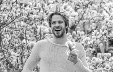 Tazelik ve uyanış. Bahar ilham. Baharın neşesi. Erkek çiçek arka planı. Bahar güzeli. Modern hipster çiçekleri sever. İlkbahar konsepti. Adam çiçek parkında rahatlıyor. Botanik Bahçesi