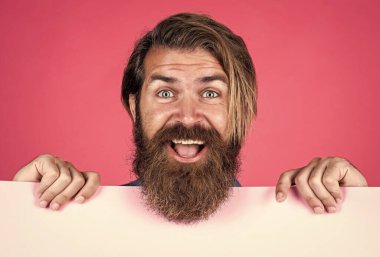 Saf mutluluk. Erkek berber yüz bakımı. Kendine güvenen ve yakışıklı. Duyuru ve reklam. Mutlu gülümseyen olgun adam. Sakallı adam pankartı tutuyor. Bıyıklı, vahşi, beyaz bir hippi.