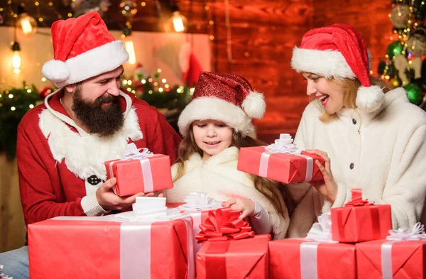 Små barn och föräldrar i tomte hatt. Glad familj firar nyår. God jul, då. Far och mor älskar dotter. Vinterlov. Shopping försäljning. Många julklappslådor. Öppen närvaro — Stockfoto