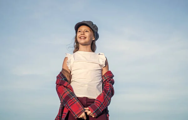 Genç kız şık bir şapka ve kareli ceket giyer gökyüzüne, özgürlüğe bakar — Stok fotoğraf