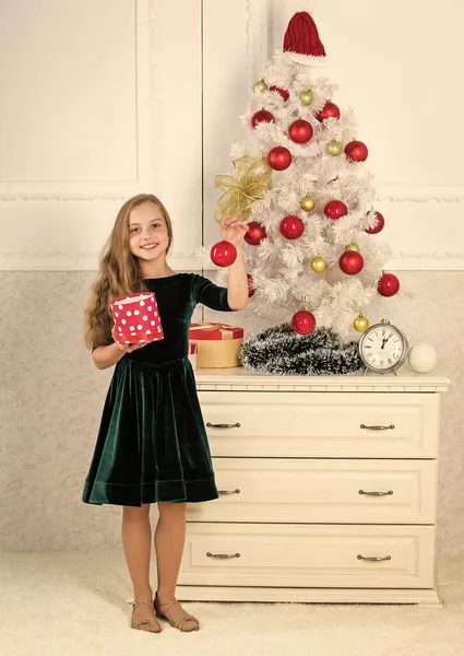 Favorite day of the year. Time to open christmas gifts. Opening christmas presents. Traditional family holiday. Kid girl near christmas tree hold gift box. Child celebrate christmas at home — Stock Photo, Image