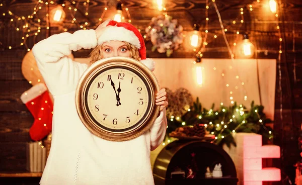 Zeit für ein Winterfest. Frau Weihnachtsmann Hut halten Vintage-Uhr. Zeit zum Feiern. Countdown zum neuen Jahr. Unerwartet bald. Mitternachtskonzept. Wünschen. Frohe Weihnachten. Zeit für Wunder. Nur noch wenige Minuten — Stockfoto