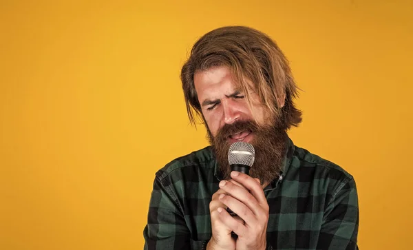 His favorite song. rock music. male karaoke singer. mature charismatic male vocalist. guy with beard singing in microphone. confidence and charisma on stage. bearded man wearing checkered shirt — Stock Photo, Image