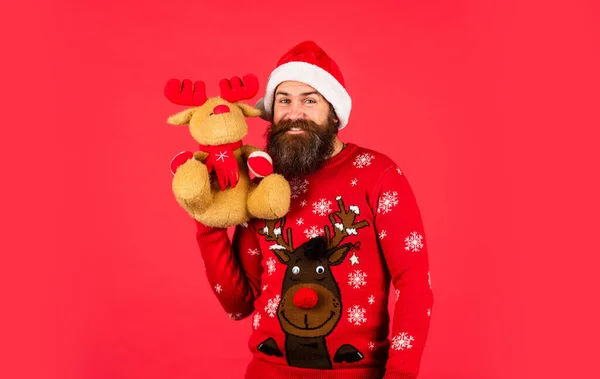 Oh my deer. Dear Santa. Bearded man reindeer toy. Hipster man hold Christmas gift. Happy man playful mood. Merry xmas. Happy new year. Helping Santa Claus. Symbol of Christmas. Christmas eve — Stock Photo, Image