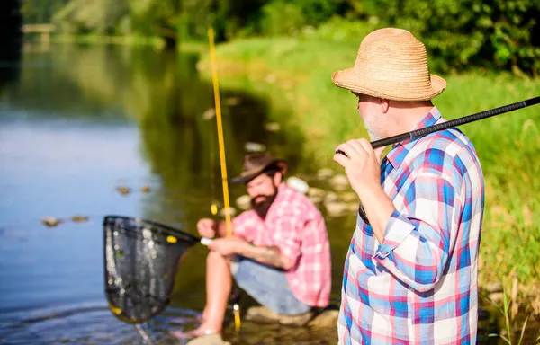 Poaching crime and fishing license. Extracts eggs from sturgeon caught river. Trap for fish. Men sit at riverside with fishing equipment. Poachers fishing. Black market caviar. Illegal hunting caviar — Stock Photo, Image