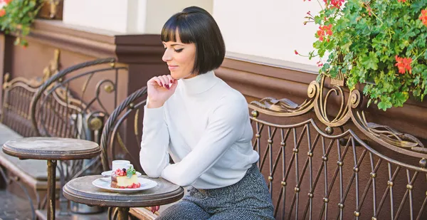 Woman attractive elegant brunette enjoy dessert and coffee cafe terrace background. Dessert concept. Pleasant time and relaxation. Delicious and gourmet snack. Girl relax cafe with coffee and dessert — Stock Photo, Image