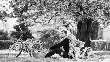 Bahar hafta sonu. Şarapla romantik piknik. Alışılmadık, benzersiz hediyeler vermek. Sevgi dolu mutlu çift, parkta yemekle dinleniyor. Mükemmel randevularının tadını çıkarıyorlar. Birbirlerine aşık çiftler.