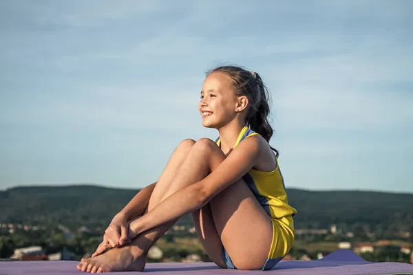 Teen girl warming up. sporty kid in sportswear outdoor. sport and