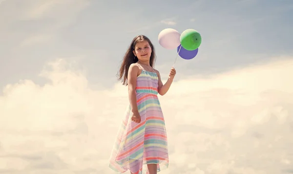 Young and free. summer holiday and vacation. freedom. beautiful teen girl. kid fashion style. female natural beauty. happy childhood. cute child on sky background with balloons. spring season weather — Stock Photo, Image