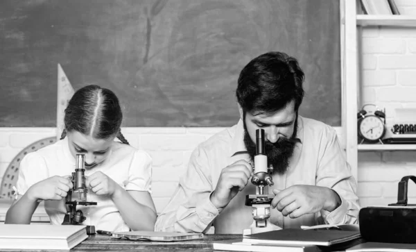 Modern education concept. back to school. math geometry. bearded man teacher with small girl in classroom. education and knowledge. biology chemistry lesson. father and daughter study in classroom — Stock Photo, Image