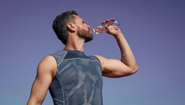 Sporcu adam antrenman, spor ve sağlıktan sonra susadığı için su içiyor.