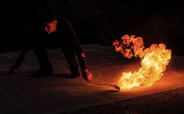 Fascinerend en gevaarlijk. De mens manipuleert met brandende poi in het donker. Brandstof en energie verbranden. Vonken en lichten. Nachtshow. Vuurprestaties. Flirt met gevaar — Stockfoto