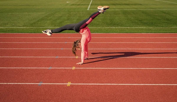 Zdrowe dziecko dziewczyna trening fitness na stadionie bieżni, gimnastyka — Zdjęcie stockowe