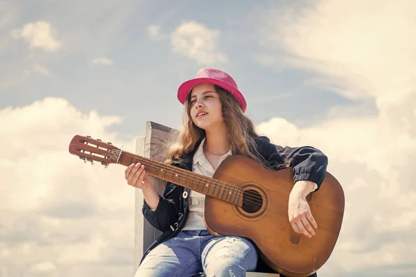 Her perfect style. happy childhood. cute child play guitar outdoor. music and song. vocal school. beautiful teen girl with acoustic guitar. kid country fashion style. female singer and guitarist — Stock Photo, Image