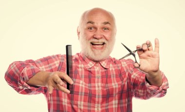 Berber keskin makasla çalışır. Sakallı yakışıklı kuaför, sakal şekillendirme aleti kullanıyor. Berber dükkanı konsepti. Erkek tıraşı. Saç kes. Berber profesyonel ekipman kullanır. Kuaför servisi