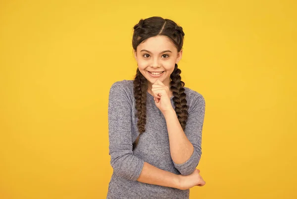 Portrait of happy girl smiling. young beautiful smiling girl with fashionable hairstyle. carefree kid posing on yellow background. Positive emotions. hairdresser salon for kids — Stock Photo, Image