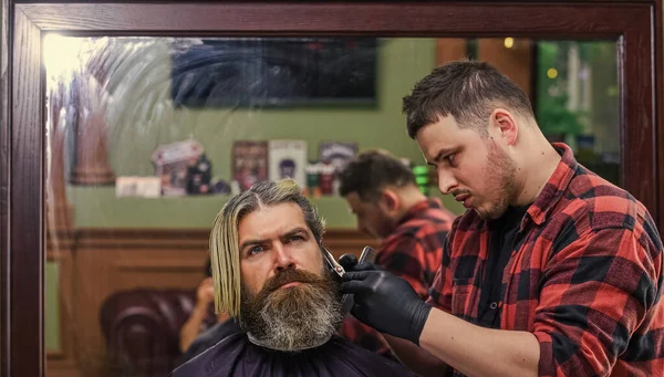 Torne-se um super-herói barbeiro. cliente visitando cabeleireiro. Hora do novo corte de cabelo. o homem olha para o reflexo do espelho. homem bonito maduro com cabelo. barbeiro ou ferramenta de cabeleireiro. hipster brutal na barbearia — Fotografia de Stock