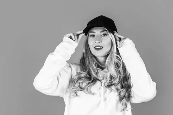 Menina desportiva em boné. Estilo hipster. moda e beleza. mulher sexy tem cabelo encaracolado loiro longo — Fotografia de Stock