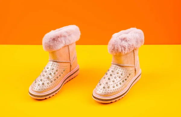 Pair of fashionable winter beige ugg boots on yellow background, new pair — Stock Photo, Image