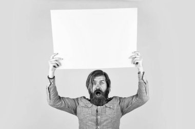 amazed bearded brutal man with moustache hold paper shit for copy space, advertisement