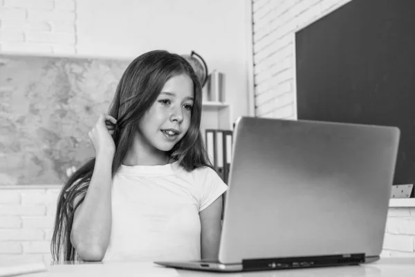 Veselá dětská práce na notebooku ve školní třídě během online moderního vzdělávání, domácí výuka — Stock fotografie