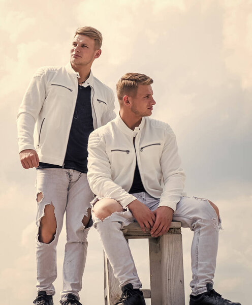 unite. confident casual models. twins brother in white. male beauty and fashion.