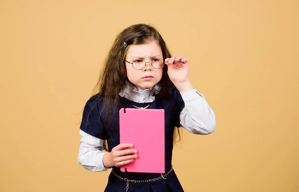 Serious small girl wants to be teacher. notebook for diary notes. study lesson. knowledge and education. Back to school. hometwork. small girl with paper folder. School curriculum — Stock Photo, Image