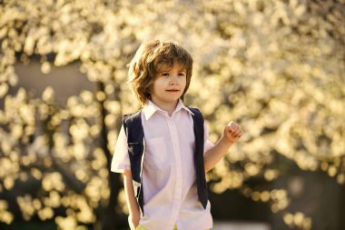Zamana göre. Yaz ve bahar modası. Çocuk kısmen doğanın çiçeklenmesinden hoşlanıyor. çocukluk mutluluğu. Güneş ışığı altında kaygısız bir çocuk. Çiçek açan bahar ağacında küçük bir çocuk. Mutlu çocuğun gür ve sağlıklı saçları var.