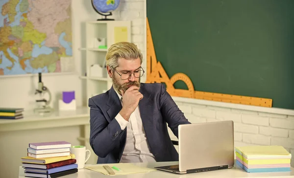 Knowledge day. School homework. Back to school. Man work school teacher sit in classroom. Handsome hipster mature smart educator. Use laptop and internet. Officially submitted application online — Stock Photo, Image