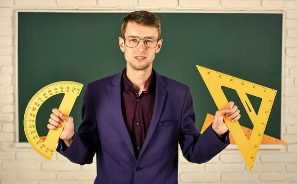 Education at school. stem school disciplines. mathematics and people. man at blackboard. back to school. what angle you look. geometry favorite subject. male teacher hold protractor and triangle — Stock Photo, Image