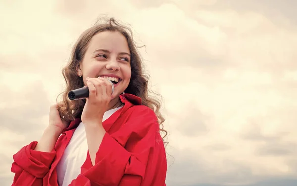 Tiener meisje zingen lied in microfoon op lucht achtergrond, live muziek — Stockfoto