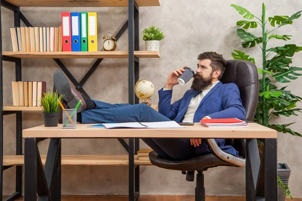 Tired manager relax drinking tea or coffee in office during working day, break — Stockfoto