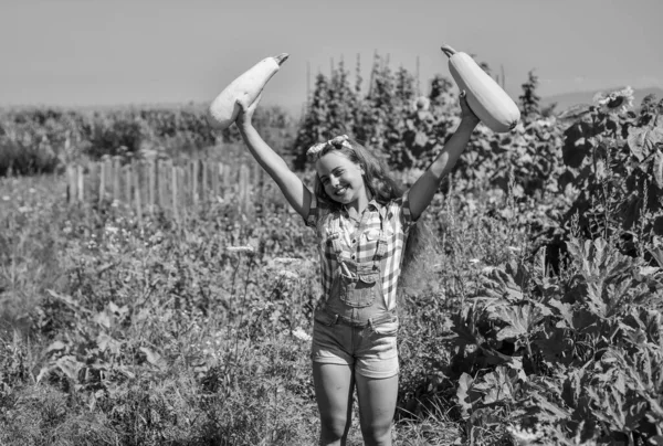 Professional gardener. teen girl on squash farm. summer vacation. rich harvest and agriculture. happy childhood. retro kid hold healthy vegetable marrow. child grow zucchini in garden, farming — Stock Photo, Image