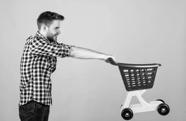 Male with fashionable groomed hair and beard carry shopping cart, discount — Stock Photo, Image