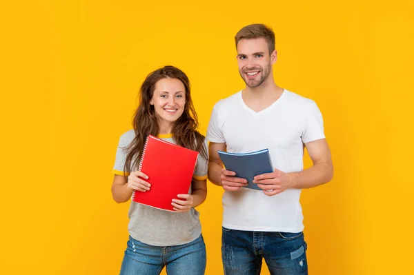 Cheerful couple hold copybook homework. back to school. modern education. — Stockfoto