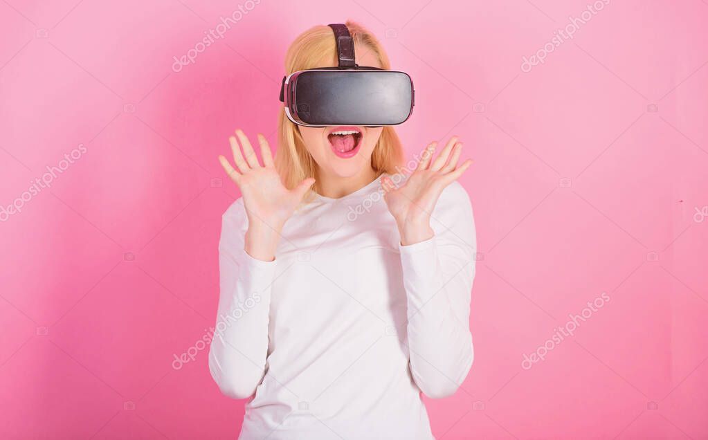 3d technology, virtual reality, entertainment, cyberspace and people concept. Amazed young woman touching the air during the VR experience. Woman enjoying cyber fun experience in vr.