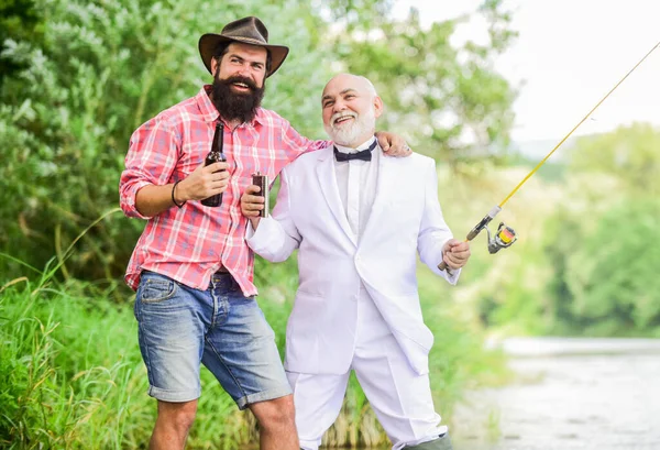 Men relaxing nature background. Fun and relax. Weekend time. Fishing skills. Set up rod with hook line and sinker. Fishing and drinking beer. Bearded man and elegant businessman fishing together — Zdjęcie stockowe